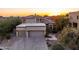 Elegant stucco home with tile roof, multi-car garage, and desert landscaping at sunset at 12026 N 138Th St, Scottsdale, AZ 85259