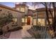 Inviting front entrance with stone pathway, desert landscaping, and warm lighting at 12026 N 138Th St, Scottsdale, AZ 85259