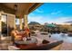 Comfortable outdoor patio furniture with mountain views adjacent to a large pool and spa at 12026 N 138Th St, Scottsdale, AZ 85259