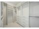 Spacious walk-in closet featuring custom shelving, drawers, and ample storage space for an organized wardrobe at 12026 N 138Th St, Scottsdale, AZ 85259