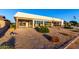 Expansive backyard featuring desert landscaping, stepping stones, and a covered patio with sliding glass doors at 12539 W Paintbrush Dr, Sun City West, AZ 85375