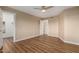 Neutral bedroom showcases hardwood floors, a ceiling fan, and interior doors to other rooms at 12539 W Paintbrush Dr, Sun City West, AZ 85375