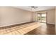 Inviting bedroom with wood-look floors and a sliding glass door to the patio at 12539 W Paintbrush Dr, Sun City West, AZ 85375