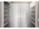 Spacious closet with double doors and built-in shelving for organized storage at 12539 W Paintbrush Dr, Sun City West, AZ 85375