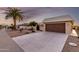 Well-maintained home featuring a two-car garage, desert landscaping, and palm trees at 12539 W Paintbrush Dr, Sun City West, AZ 85375