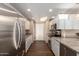 Bright, updated kitchen featuring stainless steel appliances, white cabinetry and granite countertops at 12539 W Paintbrush Dr, Sun City West, AZ 85375