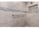 Walk-in shower showcases updated tile, pebble floor, and a built-in niche at 12539 W Paintbrush Dr, Sun City West, AZ 85375