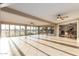 Bright sun room open to the dining area with tile floors, ceiling fans, and golf course views at 12539 W Paintbrush Dr, Sun City West, AZ 85375