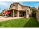 Spacious backyard with a covered patio, artificial grass, and outdoor seating at 13566 N 93Rd Pl, Scottsdale, AZ 85260