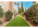 Lush backyard featuring artificial grass, manicured landscaping, and access to a pool at 13566 N 93Rd Pl, Scottsdale, AZ 85260