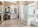 Spacious bathroom with a glass-enclosed shower, soaking tub, and a vanity area with a mirror at 13566 N 93Rd Pl, Scottsdale, AZ 85260