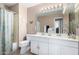 Neutral toned bathroom with double sink vanity, large mirror, and shower/tub combo with curtain at 13566 N 93Rd Pl, Scottsdale, AZ 85260