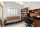 Bedroom offering a futon, natural light from a large window and an office nook with built-in bookcase at 13566 N 93Rd Pl, Scottsdale, AZ 85260