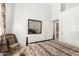 Bedroom with a bed, woven chair, and view into the ensuite bathroom at 13566 N 93Rd Pl, Scottsdale, AZ 85260