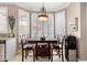 Dining area with a large window and shuttered blinds with a modern chandelier at 13566 N 93Rd Pl, Scottsdale, AZ 85260