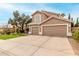 Spacious home featuring a well-manicured lawn and a three-car garage with a long driveway at 13566 N 93Rd Pl, Scottsdale, AZ 85260