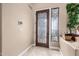 Elegant foyer featuring decorative glass door, tile flooring, and designer touches at 13566 N 93Rd Pl, Scottsdale, AZ 85260