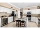 Bright kitchen with granite countertops, a wine fridge, and stainless steel appliances at 13566 N 93Rd Pl, Scottsdale, AZ 85260