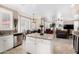 Bright kitchen features a center island with granite countertops and views into the dining and living areas at 13566 N 93Rd Pl, Scottsdale, AZ 85260