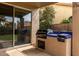 Outdoor kitchen featuring built-in grill and counter space adjacent to the covered patio at 13566 N 93Rd Pl, Scottsdale, AZ 85260