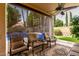 Covered patio features an outdoor ceiling fan, seating with views of the pool and landscaped backyard at 13566 N 93Rd Pl, Scottsdale, AZ 85260