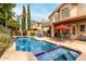 Resort-style backyard with pool, spa, covered patio, and lush landscaping for privacy at 13566 N 93Rd Pl, Scottsdale, AZ 85260