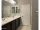 Bathroom featuring double vanity sinks and large mirror at 1367 S Country Club Dr # 1315, Mesa, AZ 85210