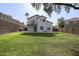 Lush backyard featuring a large grassy area and a modern home exterior with a balcony, perfect for outdoor enjoyment at 1447 S Portland Ave, Gilbert, AZ 85296