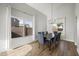 Bright dining room features wood floors, a modern chandelier, and large windows offering great natural light at 1447 S Portland Ave, Gilbert, AZ 85296