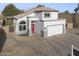 Well-maintained house with a two-car garage, low-maintenance front yard, and a charming red door at 1447 S Portland Ave, Gilbert, AZ 85296