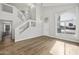 Bright living room with sleek hard wood floors, white trim, and staircase at 1447 S Portland Ave, Gilbert, AZ 85296