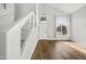 Bright living room with sleek hard wood floors, white trim, and staircase at 1447 S Portland Ave, Gilbert, AZ 85296