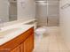 Bathroom featuring a shower and tub combination with glass doors, and a sink with wood cabinetry at 1645 W Baseline Rd # 2050, Mesa, AZ 85202