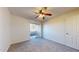 Bright bedroom with a ceiling fan and sliding glass doors leading to a balcony with neighborhood views at 1645 W Baseline Rd # 2050, Mesa, AZ 85202