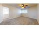 Bright bedroom featuring a window, ceiling fan, neutral walls, and carpeted floors at 1645 W Baseline Rd # 2050, Mesa, AZ 85202