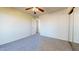 A cozy bedroom featuring a ceiling fan, carpeted floors, and a sliding door closet at 1645 W Baseline Rd # 2050, Mesa, AZ 85202