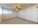 Spacious bedroom with neutral carpet, a ceiling fan, and a window at 1645 W Baseline Rd # 2050, Mesa, AZ 85202