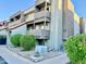 Three-story condo unit showcasing balconies, desert landscaping, and modern architectural design at 1645 W Baseline Rd # 2050, Mesa, AZ 85202