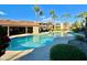 Beautiful community pool with clear blue water, palm trees, and ample seating for residents at 1645 W Baseline Rd # 2050, Mesa, AZ 85202