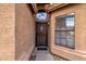 Inviting front entry features a decorative door with a transom window and a 'hello' doormat at 16808 N 59Th Pl, Scottsdale, AZ 85254