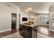 Open-concept living room with stone fireplace and chandelier lighting at 16808 N 59Th Pl, Scottsdale, AZ 85254