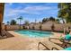 Backyard pool is surrounded by a tan concrete patio, desert landscaping, privacy wall and features lounge chairs at 16808 N 59Th Pl, Scottsdale, AZ 85254