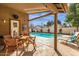 View of patio, outdoor dining set and lounge chairs, leading to a private pool in a fenced backyard at 16808 N 59Th Pl, Scottsdale, AZ 85254