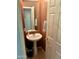 Powder bathroom featuring unique paint, neutral tones, and pedestal sink at 17012 S 27Th Ln, Phoenix, AZ 85045