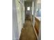 Light-filled hallway featuring neutral paint, carpeted floor, and a wooden railing looking over the second floor at 17012 S 27Th Ln, Phoenix, AZ 85045