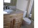 Bathroom featuring a wood vanity with granite countertop, a toilet, and a glass-enclosed shower at 17019 N Pinion Ln, Sun City, AZ 85373