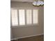 Bedroom featuring a window with white shutters for adjustable natural light at 17019 N Pinion Ln, Sun City, AZ 85373