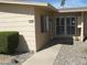 The exterior of this home features desert landscaping, light-colored siding, and a cozy front entrance at 17019 N Pinion Ln, Sun City, AZ 85373