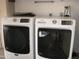 Laundry room showcasing a modern washer and dryer for efficient clothes care at 17019 N Pinion Ln, Sun City, AZ 85373