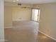 Open living space featuring tile flooring, neutral paint, and a sliding glass door to the patio at 17019 N Pinion Ln, Sun City, AZ 85373